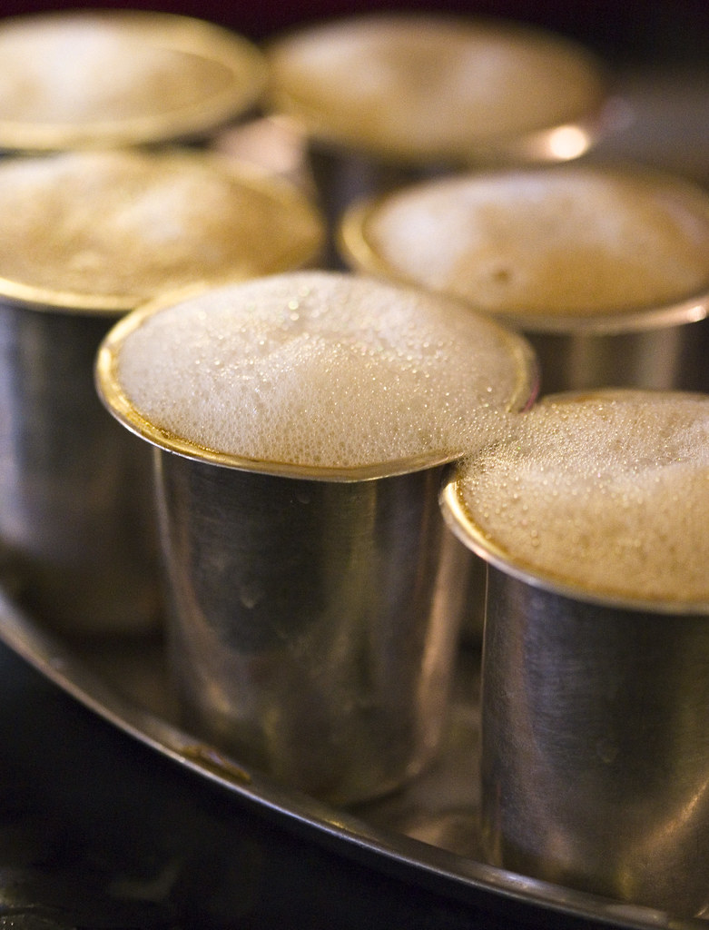 Filter coffee in a steel tumbler, market morning energy